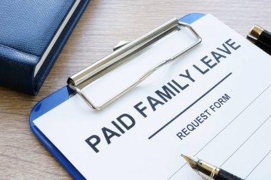 Paid family leave form in clipboard and note pad. clipart