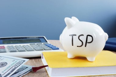 Thrift savings plan TSP written on a piggy bank. clipart