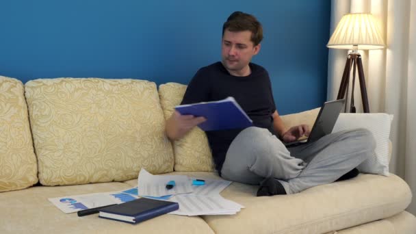 Man Sits Sofa Works Laptop Financial Charts Small Business — Stock Video