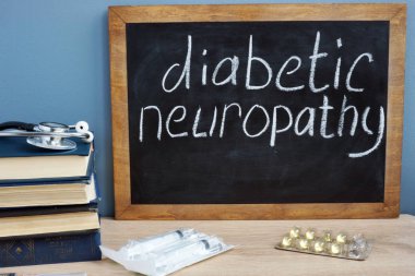 Diabetic neuropathy handwritten on a blackboard. clipart