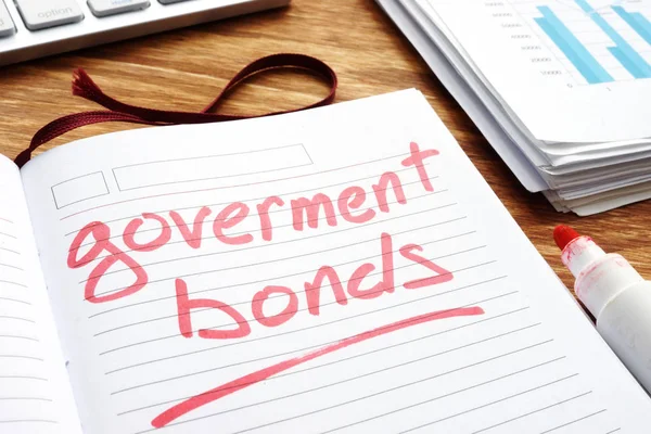 Government bonds. Notepad and papers on a desk.