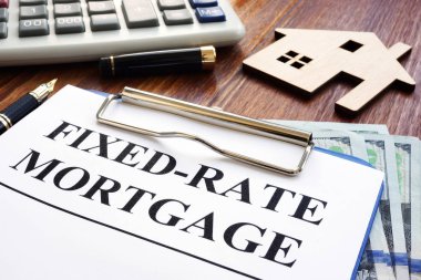 Fixed rate mortgage, wooden home and calculator. clipart