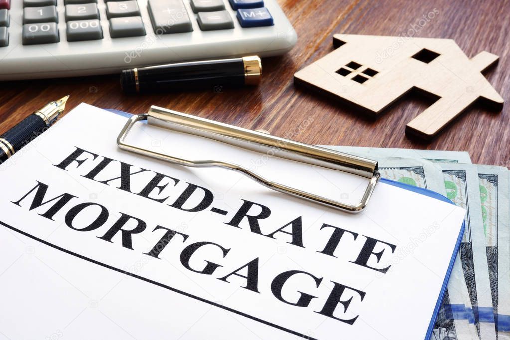 Fixed rate mortgage, wooden home and calculator.