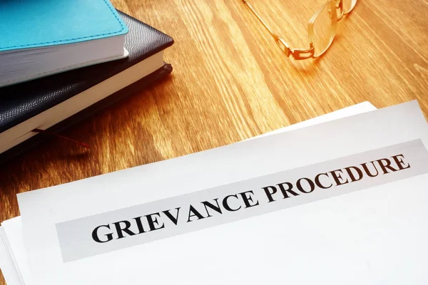 Grievance procedure documents on a table.