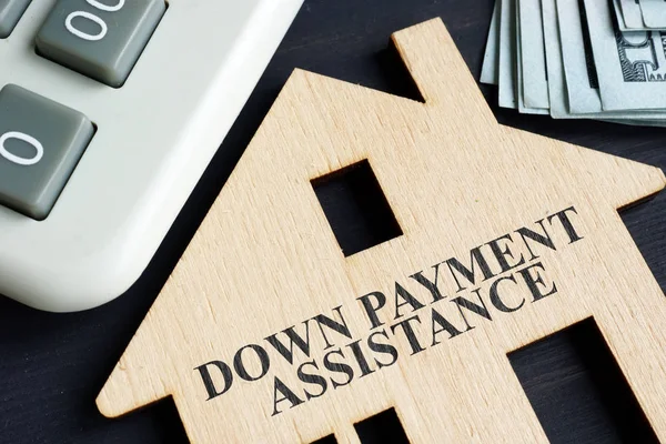 Down payment assistance written on a model of home.
