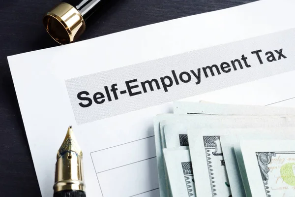 Self employment tax form and money with calculator. — Stock Photo, Image