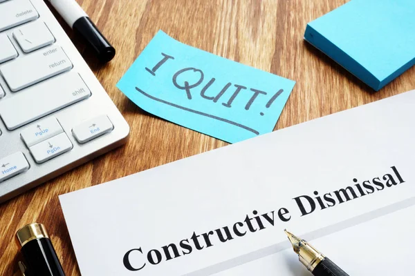 Constructive dismissal papers on the workplace. — Stock Photo, Image