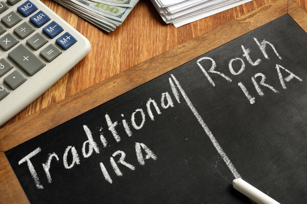 Traditional IRA vs Roth IRA written on blackboard.