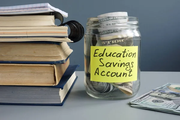 Этикетка ESA Education Saving Account на банке с деньгами и книгами . — стоковое фото