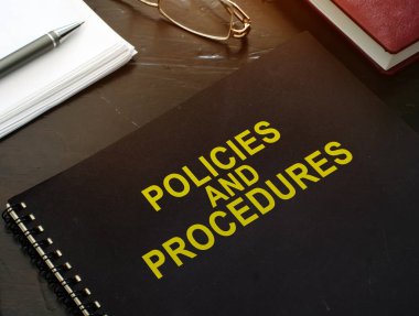 Policies and procedures company documents on a desk. clipart