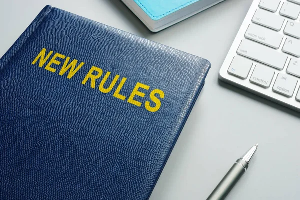 Book with title New rules and regulations in an office.