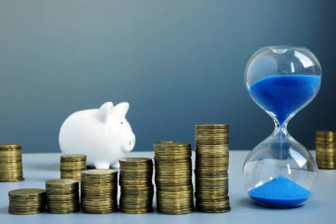 Sikke yığını ve kum saatinden ok. Zenginlik ve tasarruf.