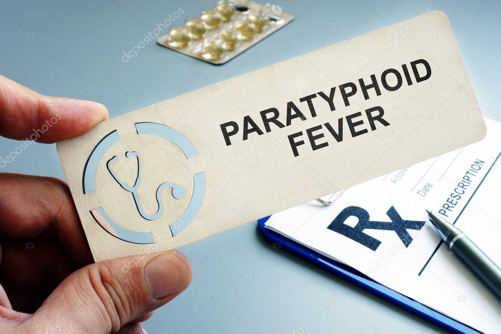 Man holding plate with sign Paratyphoid fever.