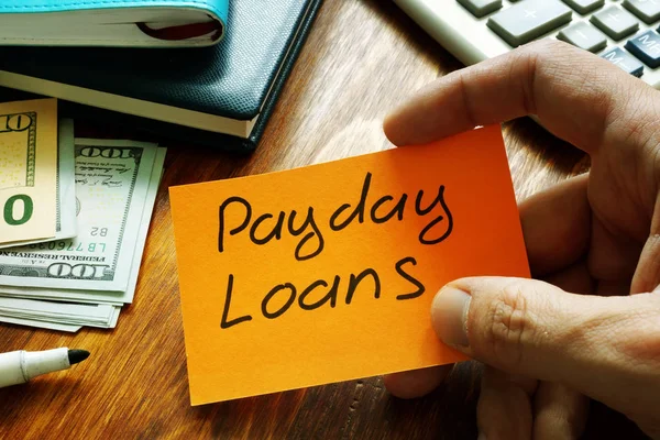 Payday loans written on a piece of paper.