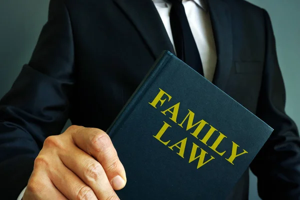 Family law book about divorce in the hands of a man. — Stock Photo, Image