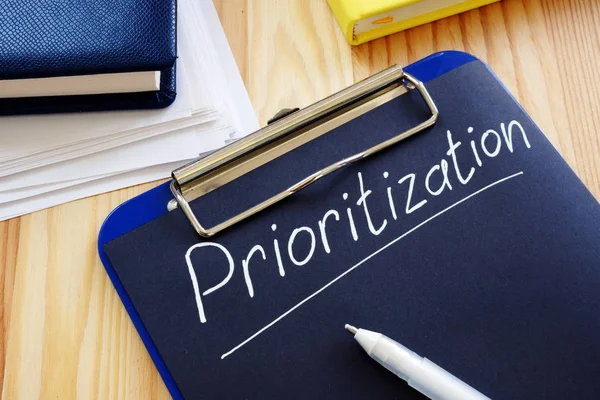 Prioritization handwritten sign on the black page. — Stock Photo, Image