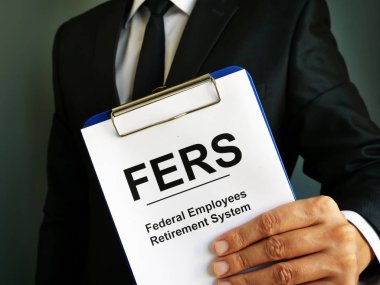 Man holds Federal Employees Retirement System FERS. clipart
