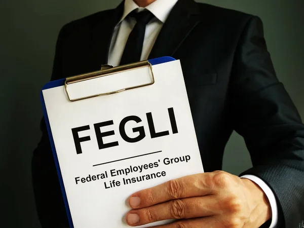 FEGLI Federal Employees Group Life Insurance policy in the hands.