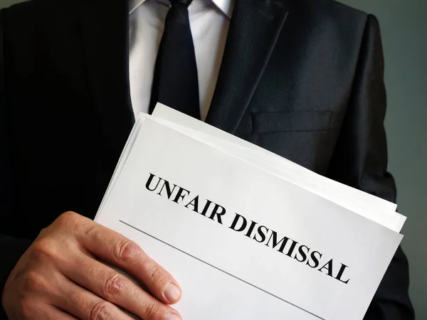 Unfair dismissal concept. Man is holding stack of papers. — Stock Photo, Image