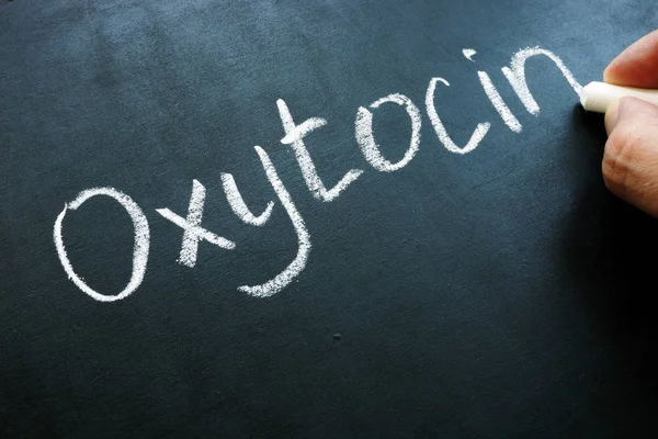 Oxytocin Oxt hormone handwritten on the blackboard.
