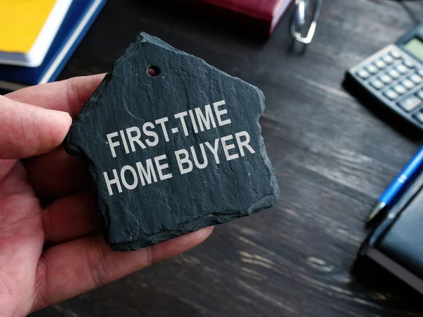First time home buyer words on the stone house symbol.