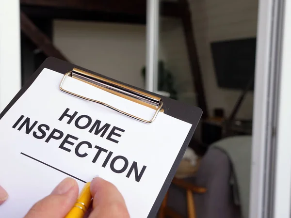 Inspector fills out the Home inspection form.