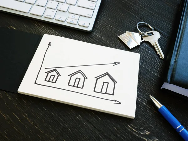 Investments in real estate. Graph with houses and an arrow. — Stock Photo, Image