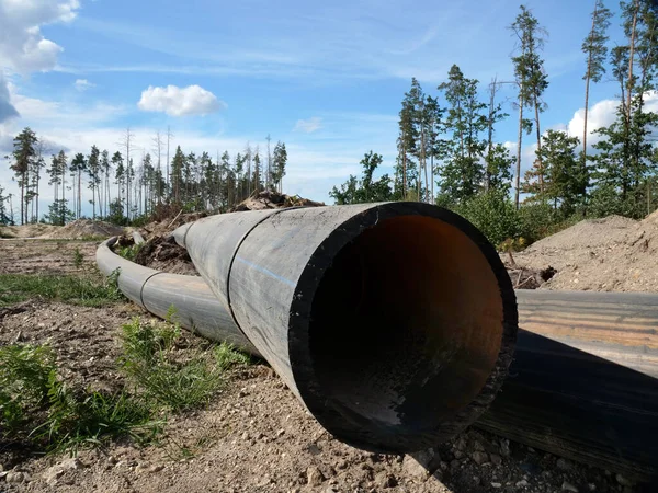 Environmental problems concept. Large pipes lay instead of felled wood. — Stock Photo, Image