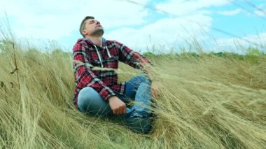 Bir turist sık sonbahar çimlerinde otururken doğada dinlenir. Dinlenme ve meditasyon.