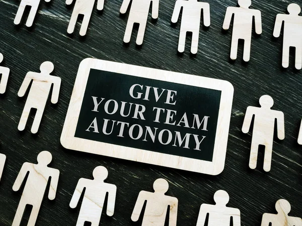 Giving your team autonomy quote and wooden figures.