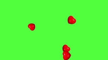 Yeşil ekran arkaplanlı kırmızı kalplerin hareket grafikleri yükseliyor