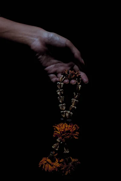 Hand Die Die Getrocknete Blumengirlande Auf Schwarzem Hintergrund Einfängt — Stockfoto