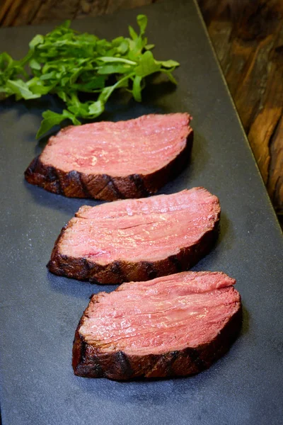 Sous-vide steak cut into pieces, cooked to eat beef on the stone table — Stock Photo, Image