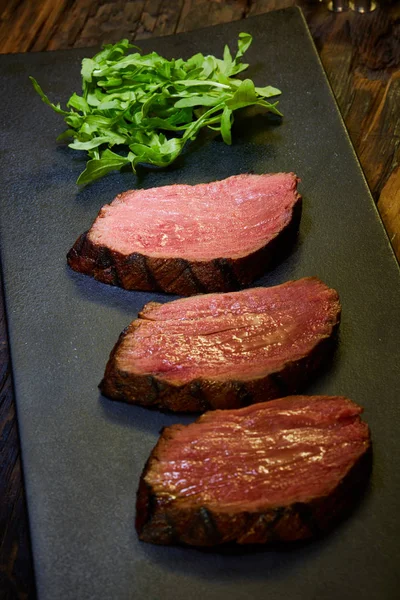 Sous-vide steak cut into pieces, cooked to eat beef on the stone table — Stock Photo, Image