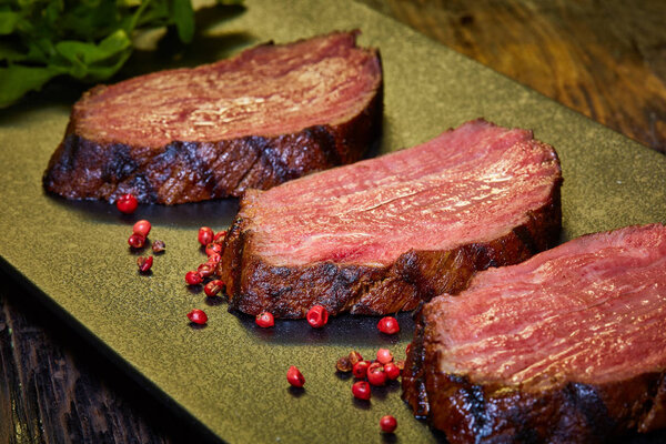 Sous-vide steak cut into pieces, cooked to eat beef on the stone table. Shallow dof