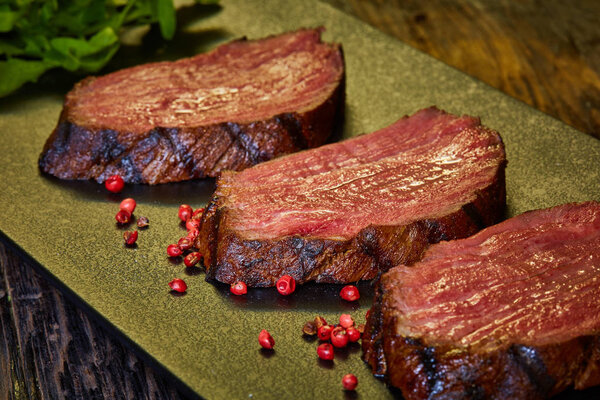 Sous-vide steak cut into pieces, cooked to eat beef on the stone table. Shallow dof