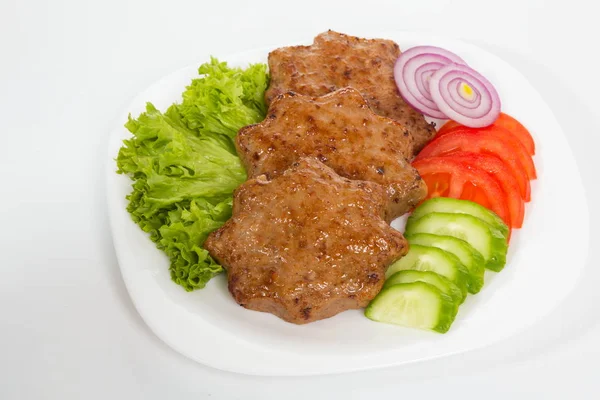 Three fried breaded cutlet with lettuce, tomatoes, cucumbers and onion on white background — Stock Photo, Image