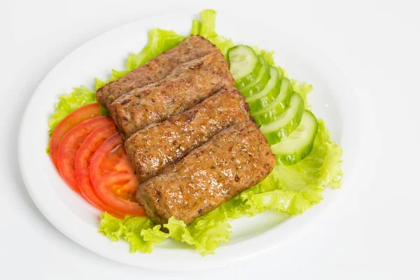 Three fried breaded cutlet with lettuce, tomatoes and cucumbers on white background — Stock Photo, Image