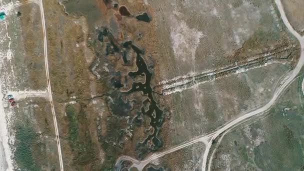 Fly over aerial view of vehicle track going into the savanna grasslands and — Stock Video