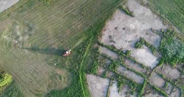 Una vista aérea de un hombre cortando su césped con una segadora . — Vídeo de stock