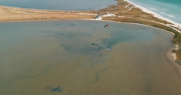 Kitesurfing in the Azov sea. Aerial 4k cinematic kite surfing top view — Stock Video