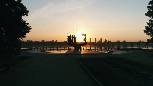 Monument voor de oprichters van Kiev bij zonsopgang, mooie stadsgezicht in de brandende zon. Standbeeld van Kyi, Shchek, Horyv en Lybid over de Paton-brug. Hoofdstad van Oekraïne — Stockvideo