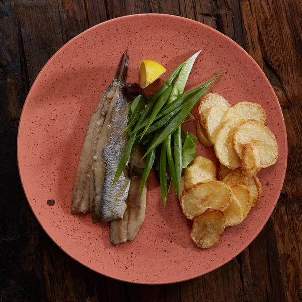 Pacific herring with fried potatoes and onion — Stock Photo, Image