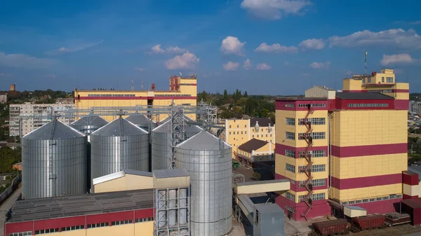 Agricultural Silo. Storage and drying of grains, wheat, corn, soy, against the blue sky with clouds. — Stock Photo, Image