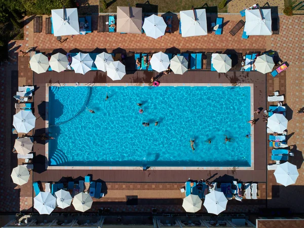 Aerial view on people in swimming pool. Top view of people sunbathing pool. — Stock Photo, Image