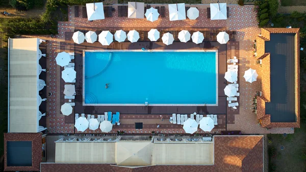 Aerial view on people in swimming pool. Top view of people sunbathing pool. — Stock Photo, Image