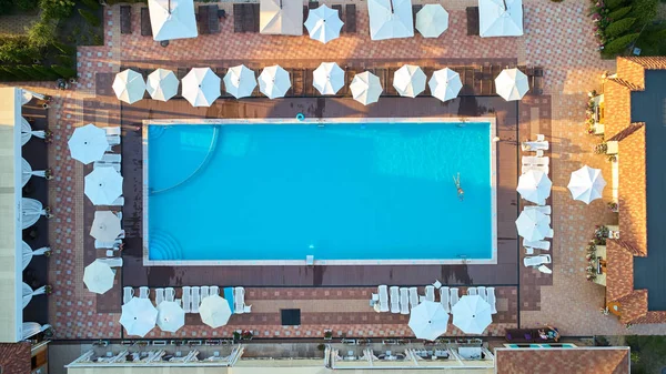 Aerial view on people in swimming pool. Top view of people sunbathing pool. — Stock Photo, Image
