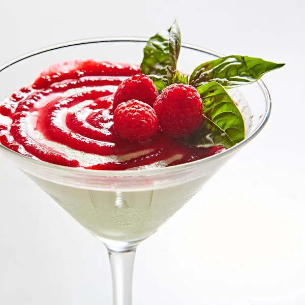 Delicious Italian dessert Panna Cotta with raspberry in small transparent glass — Stock Photo, Image