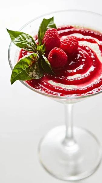 Delicious Italian dessert Panna Cotta with raspberry in small transparent glass — Stock Photo, Image