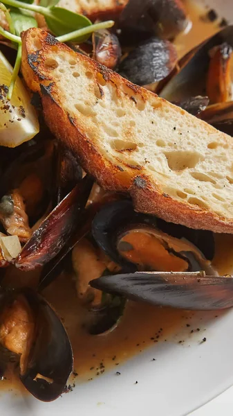 Seafood. Mussels in wine with croutons and lemon. Clams in the shells. — Stock Photo, Image